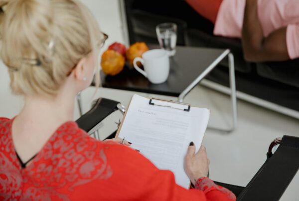 Therapist taking notes during an individual therapy session