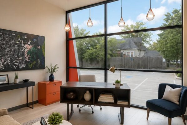 Private therapy office with a desk, armchair and large windows at Heights Behavioral Health