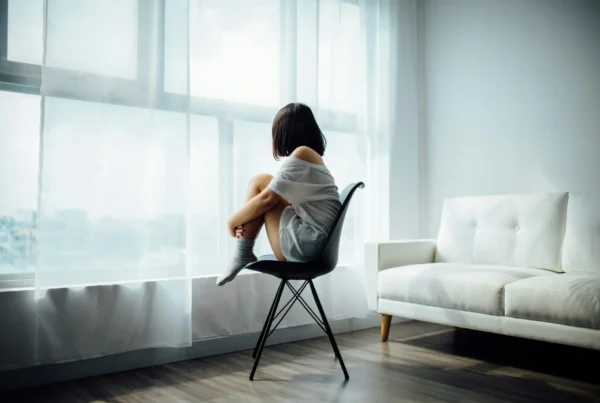 Adult coping with depression and isolation, illustrating burnout or depression