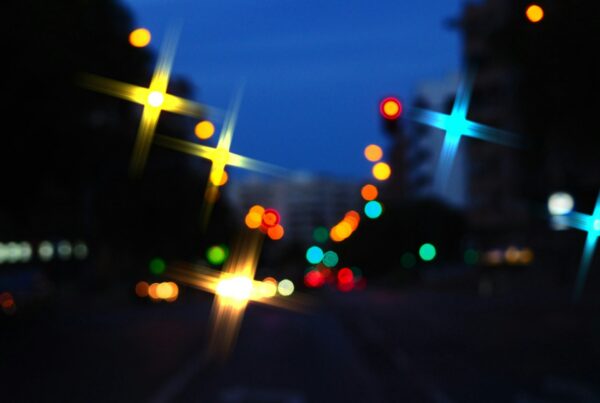 Blurred city lights on a street at night, representing nights out where cocaine and alcohol combine