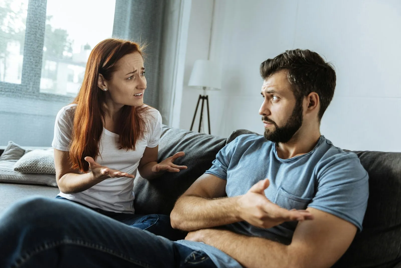 Two adults having a supportive conversation at home, illustrating gambling debt and the family