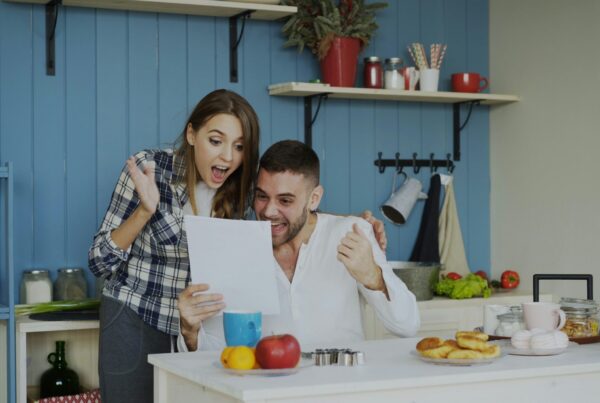 Couple reviewing documents together in their kitchen, representing understanding superbills and reimbursement